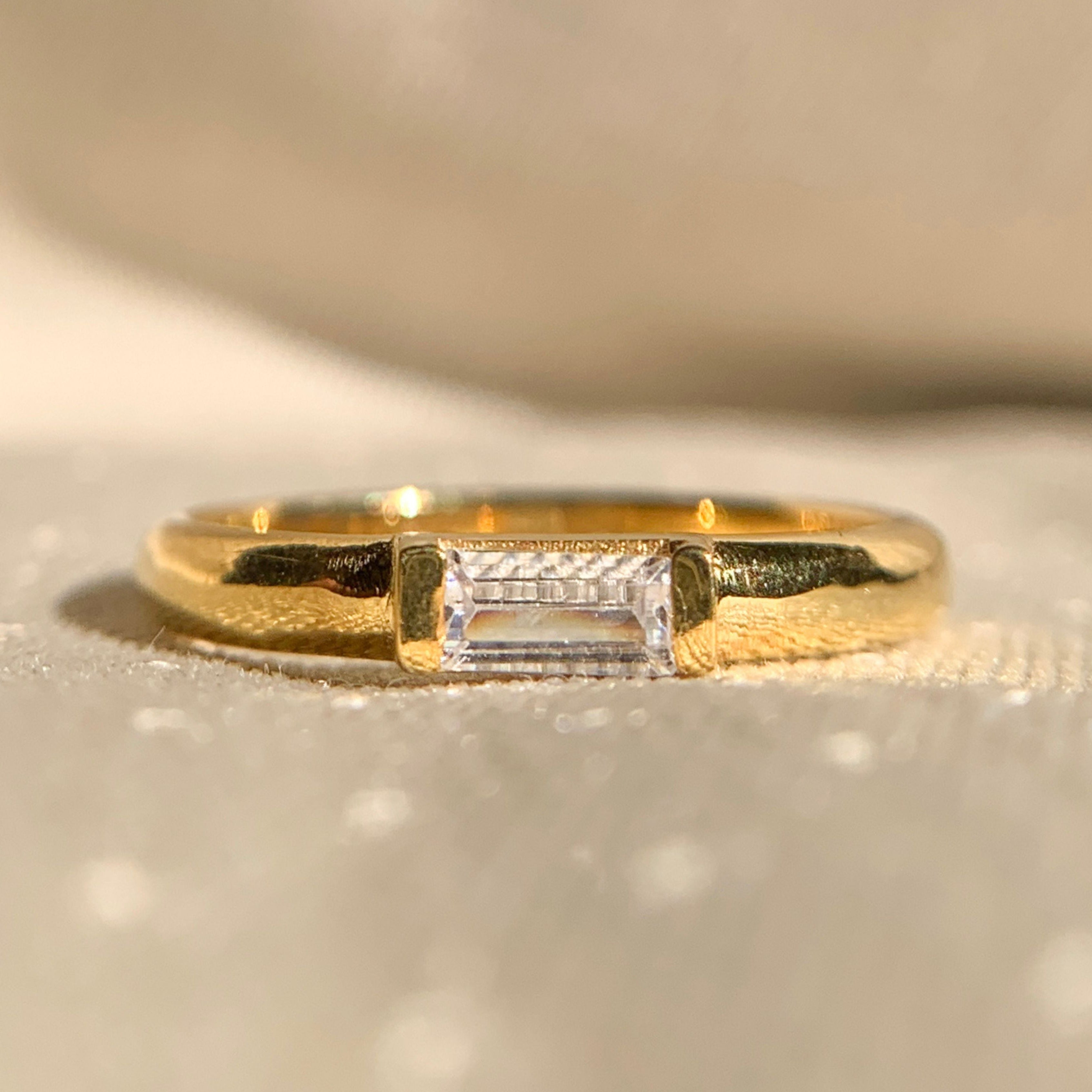 Moissanite east-west baguette diamond ring in sleek gold band